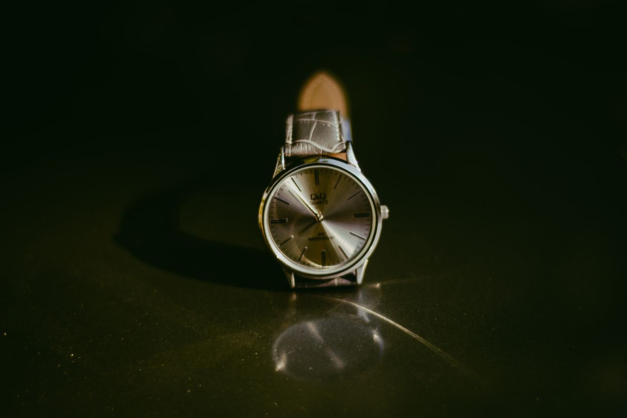 pexels photo 1467188 1467188 Classic silver wristwatch with leather strap showcased on a reflective surface, perfect for a touch of elegance.