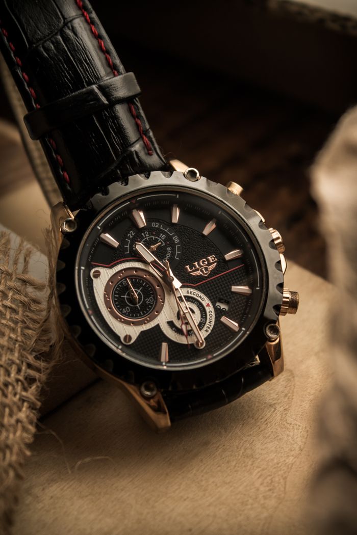 pexels photo 16093243 16093243 Close-up of a stylish wristwatch with a black leather strap and intricate dial design.